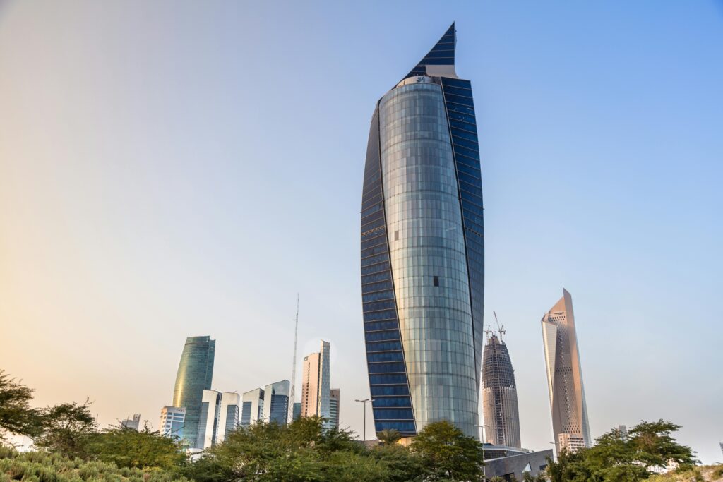 A stunning view of modern skyscrapers in Kuwait City against a clear sky, featuring iconic landmarks.